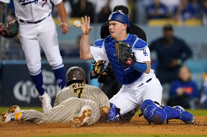 The San Diego Padres' Ha-Seong Kim scores on a sacrifice fly as Los Angeles Dodgers catcher Will Smith takes a late throw during Game 1 of the NL Division Series on Oct. 11, 2022 in Los Angeles.