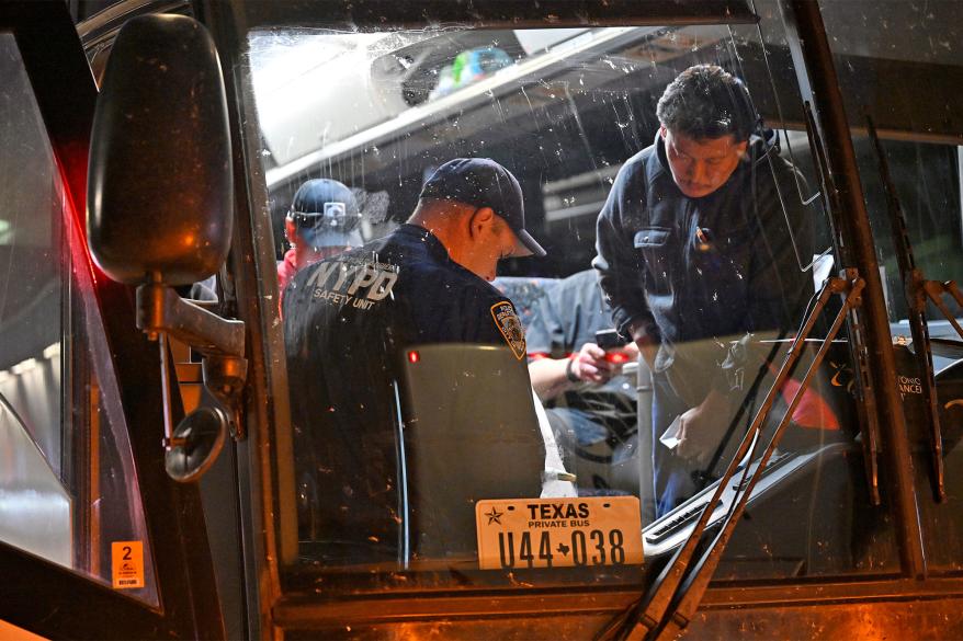 A picture of NYPD on a bus that was filled with migrants.