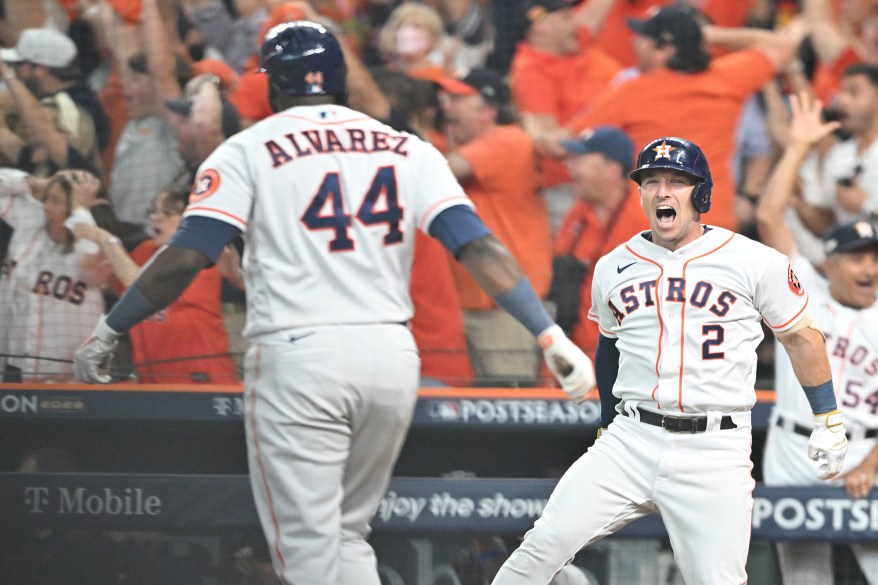 The Houston Astros' Yordan Alvarez celebrates with Alex Bregman after hitting a three-run walk off home run against the Seattle Mariners in ALDS Game 1 on Oct. 11, 2022 in Houston.