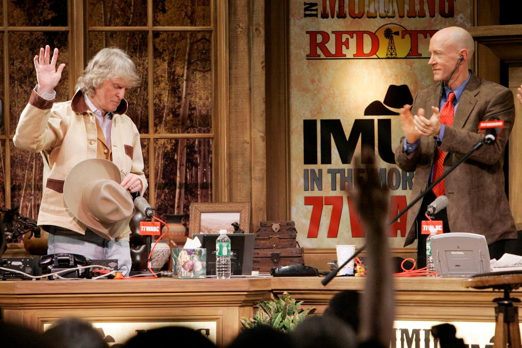 Don Imus, left, acknowledges audience applause and that of producer Bernard McGuirkat New York's Town Hall