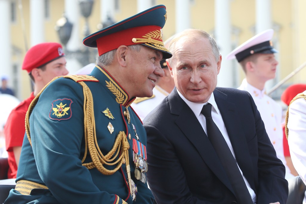 Russian Defense Minister Sergei Shoigu, left, pictured next to Vladimir Putin, told Wallace the missile firing was the result of a "technical malfunction." 