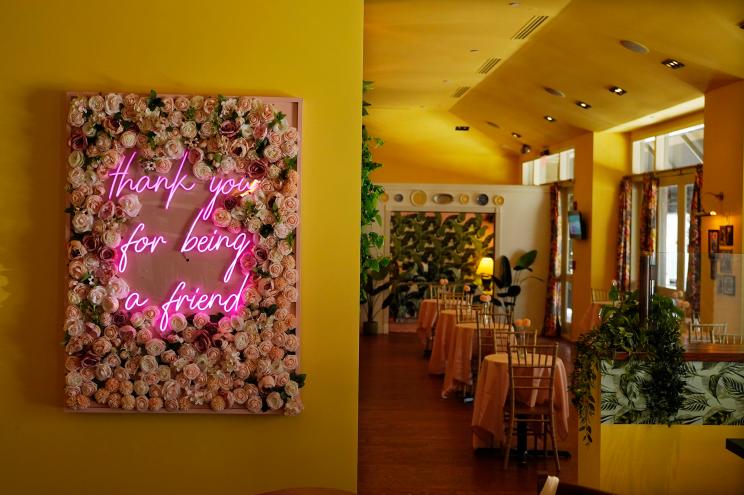 The theme song to the television series "The Golden Girls" is featured in neon lettering at the Golden Girls Kitchen pop-up restaurant on July 25, 2022, in Beverly Hills, California.