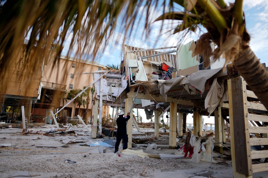 A member of Florida Task Force 8 urban search and rescue tags a condominium building that has been checked and found clear of people in Fort Myers Beach after Hurricane Ian.