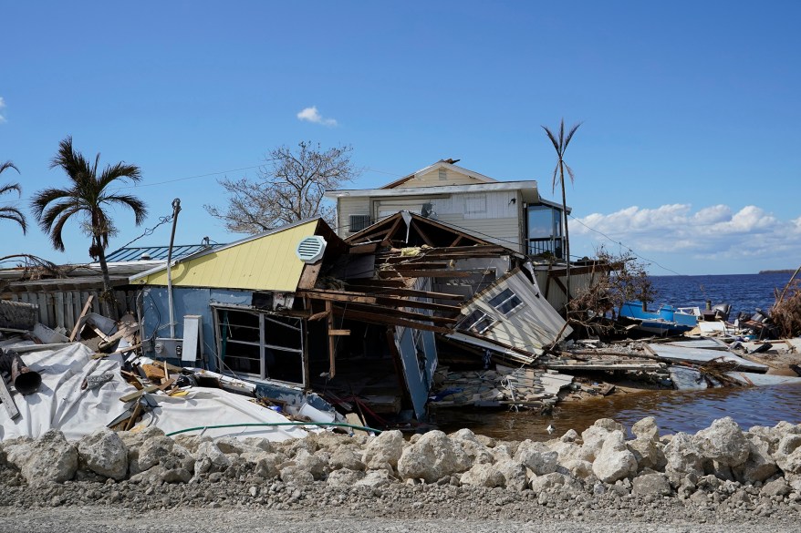 Piles of debris and homes damaged in Hurricane Ian line the roadway in Matlacha, Florida.