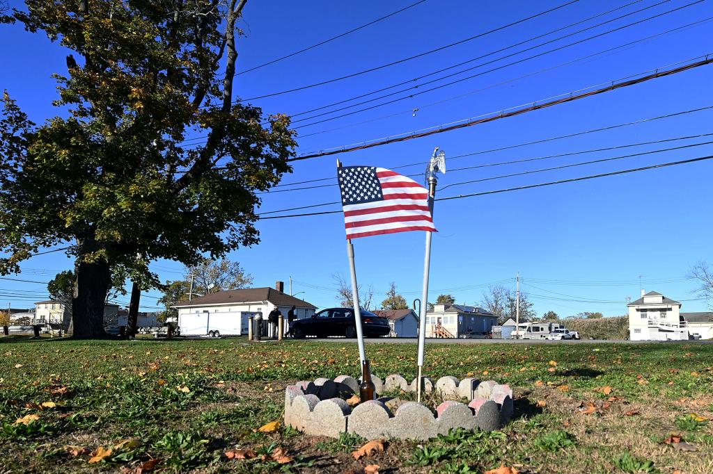 ​​A makeshift memorial remains at the home of a postal worker who lost his life to Superstorm Sandy.