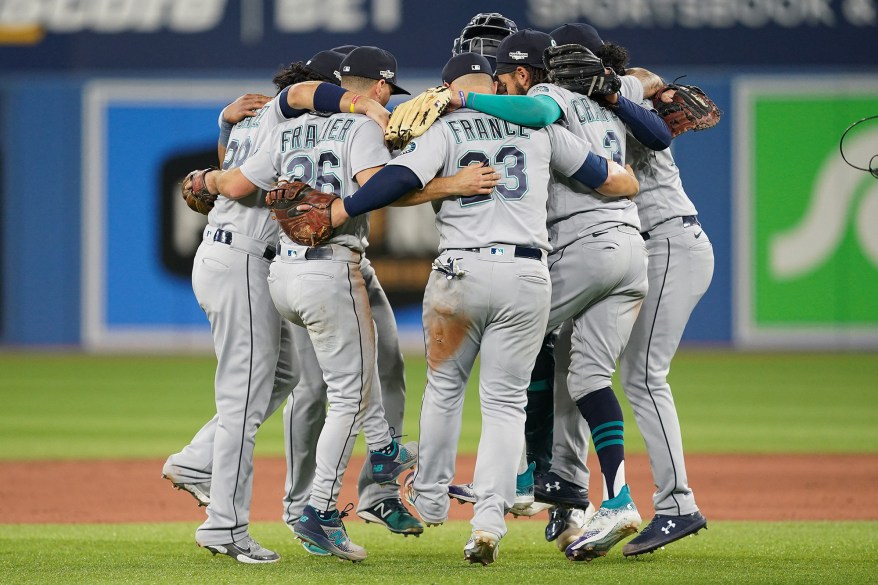 Seattle Mariners players come together after defeating the Toronto Blue Jays in Game 1 of the Wild Card Series on Oct. 7, 2022 in Toronto.