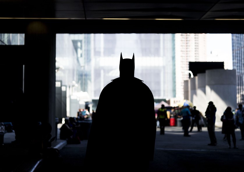 Andrew Bridges of New York walks through an underpass in his Batman costume during the first day of New York Comic Con at the Jacob K. Javits Convention Center