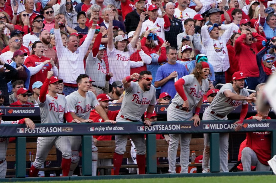 Philadelphia Phillies players celebrate a two-run single by Jean Segura during the ninth inning of NL Wild Card Game 1 against the St. Louis Cardinals on Oct. 7, 2022 in St. Louis.