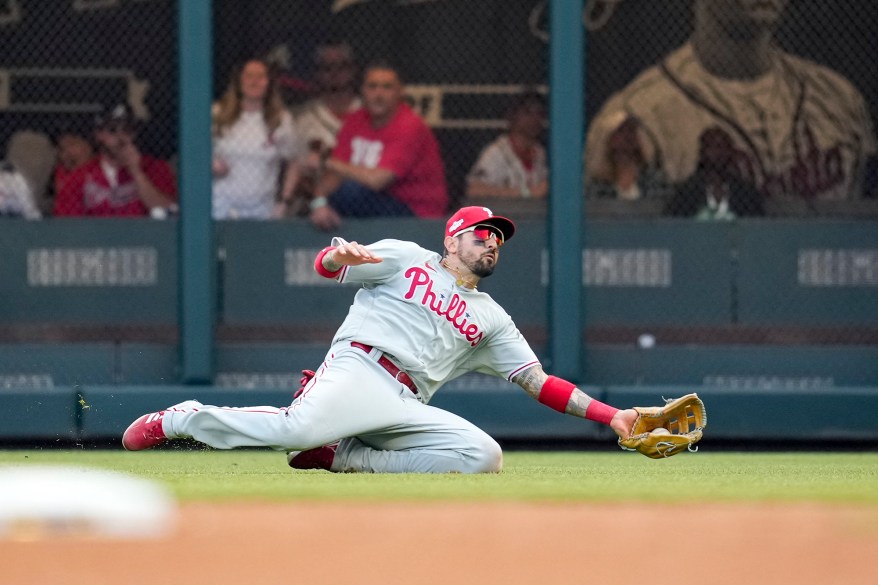 The Philadelphia Phillies' Nick Castellanos slides to make a catch in the ninth inning of Game 1 of the NLDS on Oct. 11, 2022 in Atlanta.