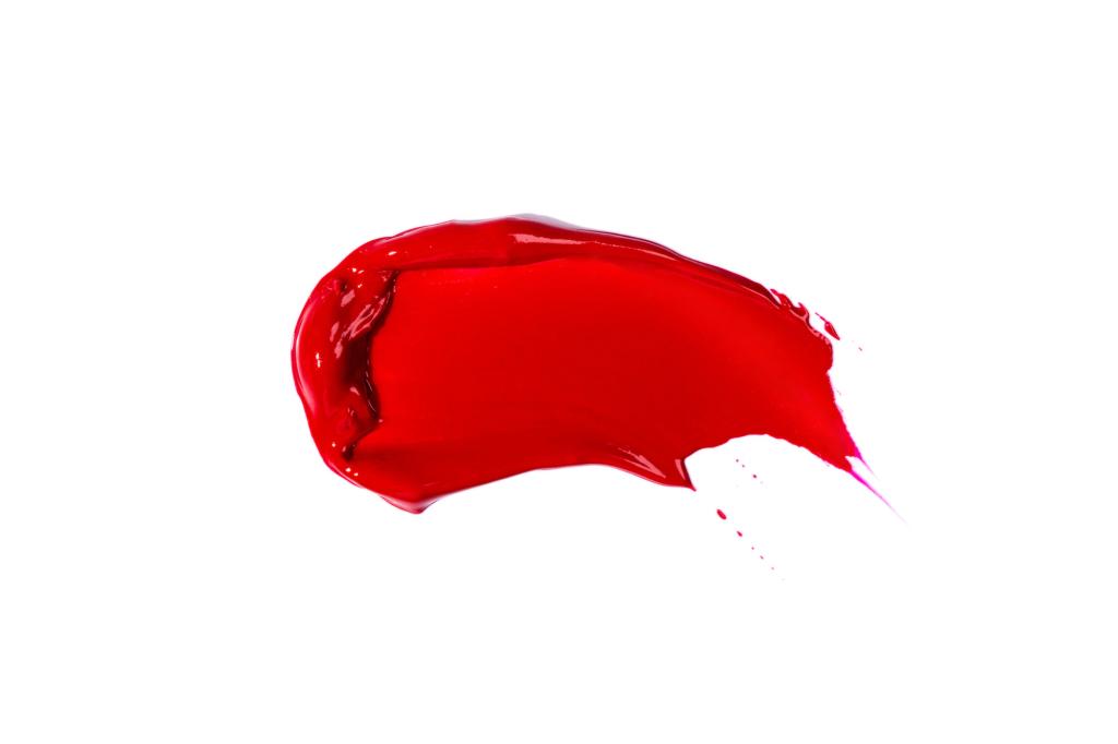 A chilli red smear of decorative cosmetics isolated on a white background.