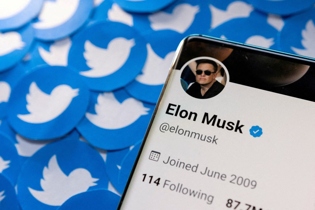 Phone showing Elon Musk's twitter profile.