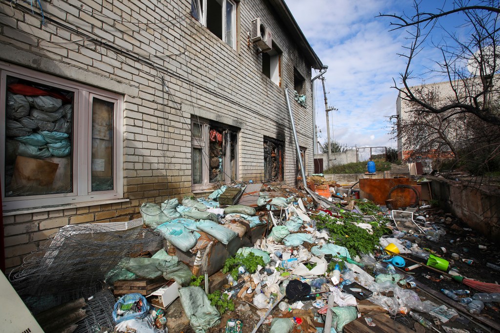 Heaps of garbage are seen at an administrative building that had been occupied by Russian forces.