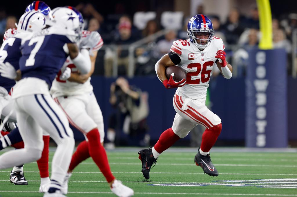 Saquon Barkley #26 of the New York Giants runs the ball during the first half in the game against the Dallas Cowboys at AT&T Stadium on November 24, 2022 in Arlington, Texas.