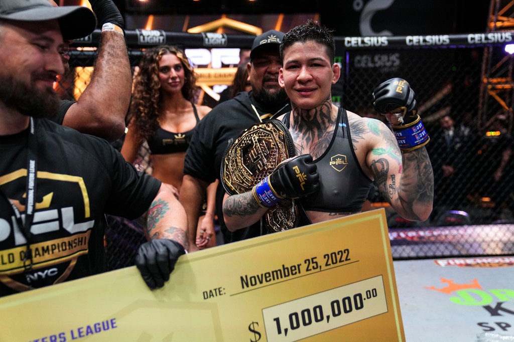 Larissa Pacheco accepts her PFL championship belt and the big check representing her $1 million prize as the women's lightweight season winner Friday night at Hulu Theater at Madison Square Garden.