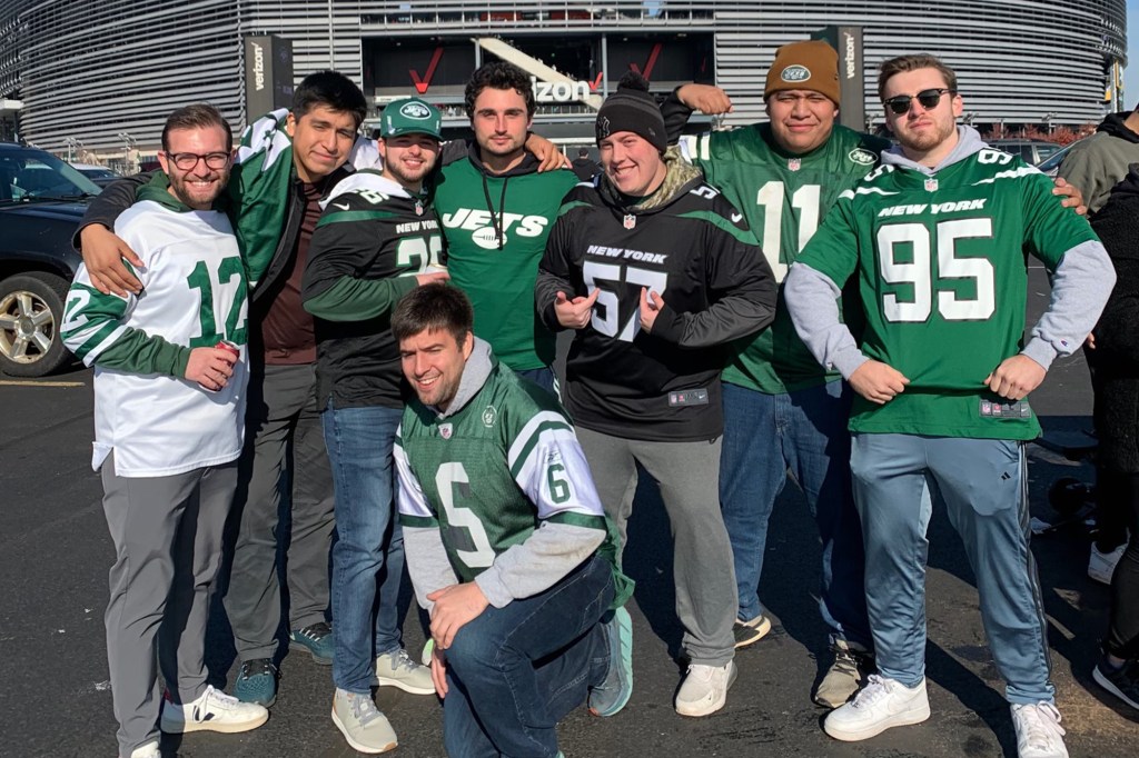 Alex Noon (kneeling) says his coin flip calls have brought Jets fans closer together. 