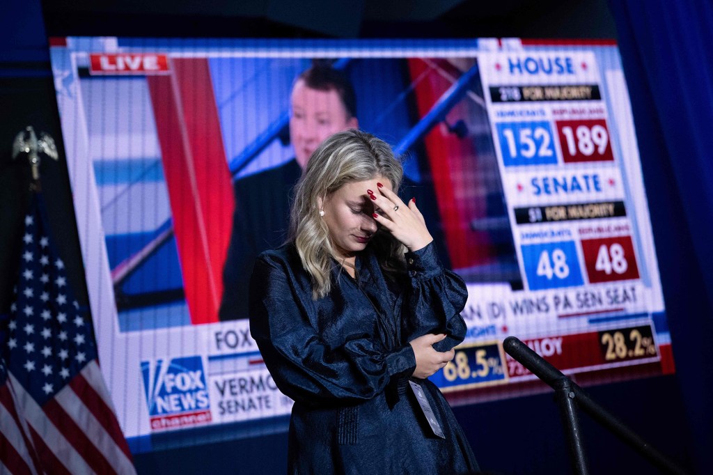 A staff member reacts to midterm election results during a election night watch party for House Minority Leader Kevin McCarthy early Wednesday morning in  Washington, DC.