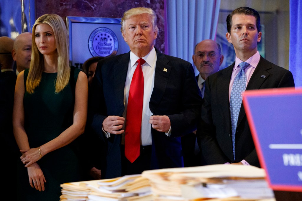 Donald Trump is pictured with his children and financial chief.