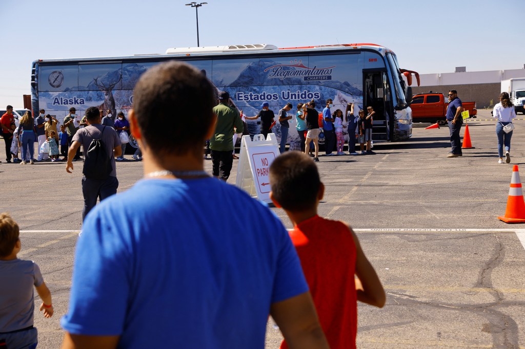 Migrants, mostly from Venezuela, queue to board a bus to New York at the Migrant Welcome Center managed by the city of El Paso and the Office of Emergency Management, in El Paso, Texas, U.S., September 16, 2022. REUTERS/Jose Luis Gonzalez