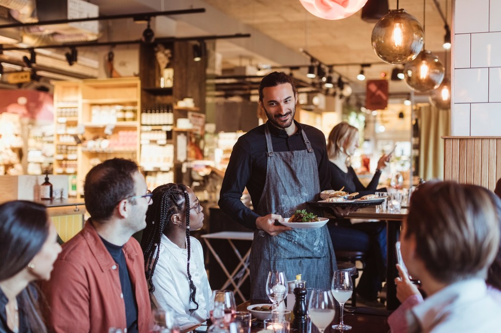 Waiter serving food