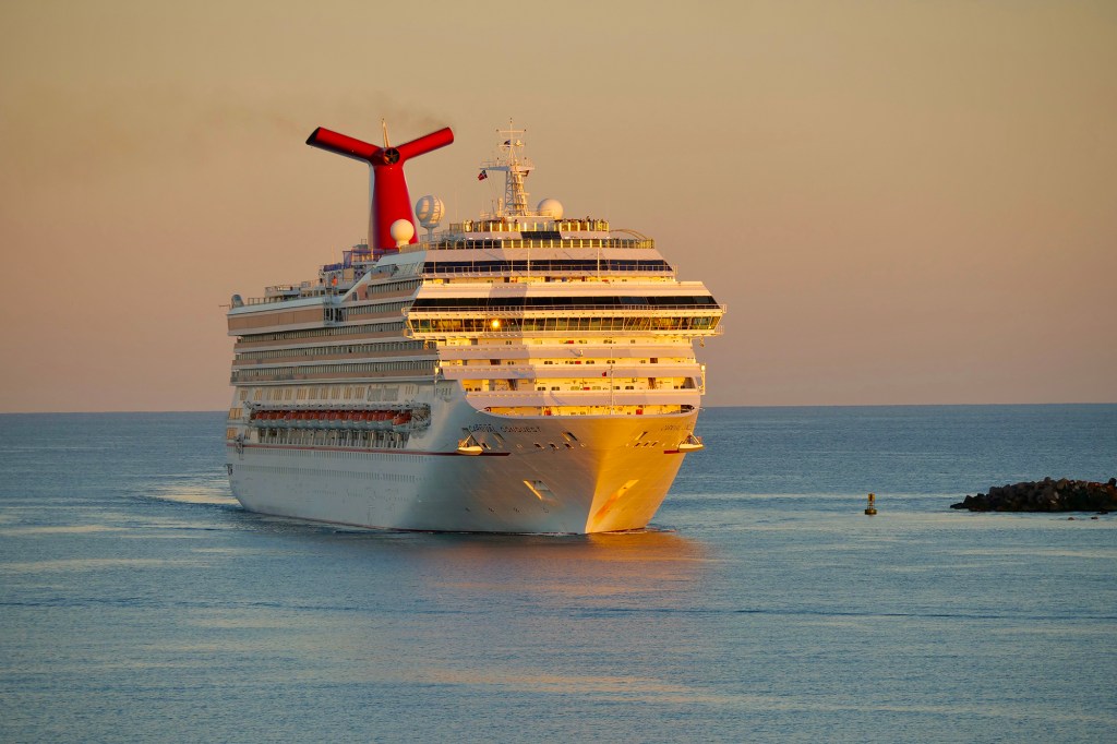 Nassau, Bahamas- December 26,2021: Cruise ship "Carnival Conquest" arrival at Nassau port. Carnival Cruise Line is an international cruise line with headquarters in Doral, Florida.