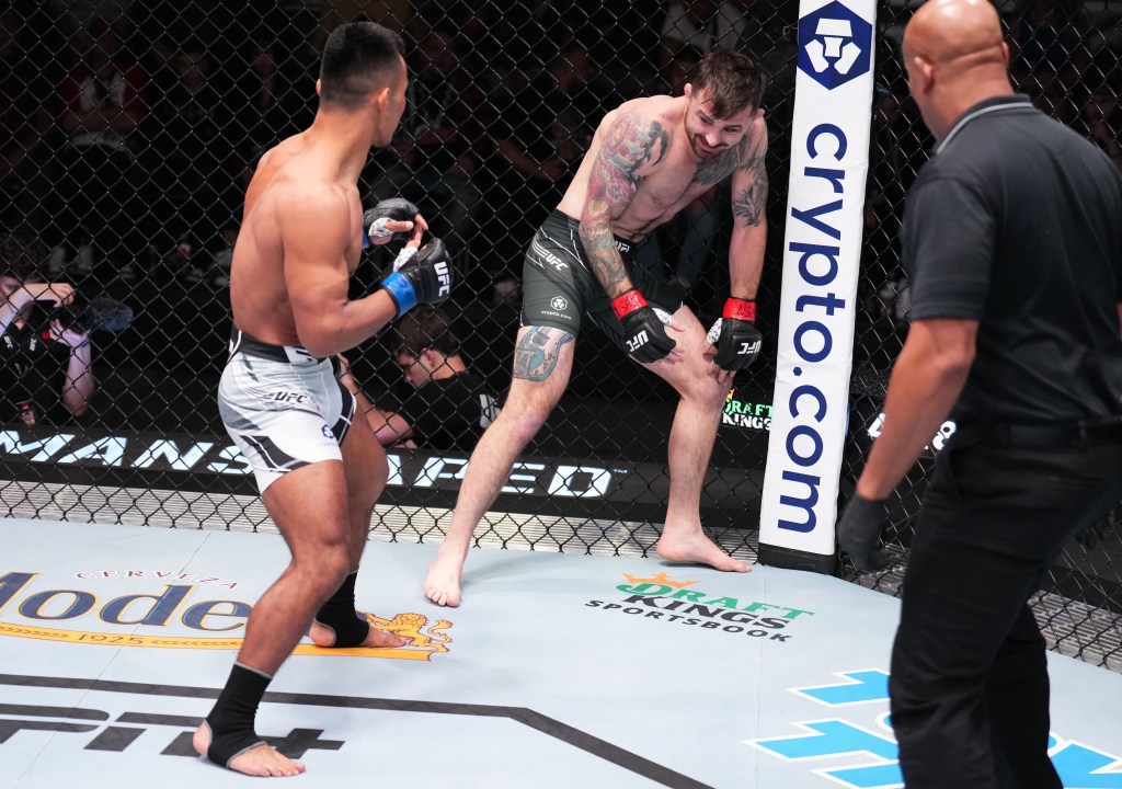 James Krause covers up grabbing his knee, in the opening minute of the fight.