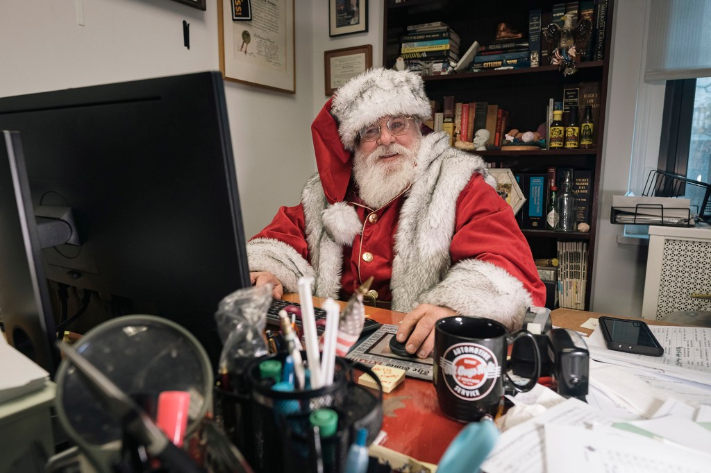 lawyer Dana "Santa" Friedman, dressed as Santa Claus at his office in the Astor building, lower Manhattan. 217 Broadway, New York, NY
