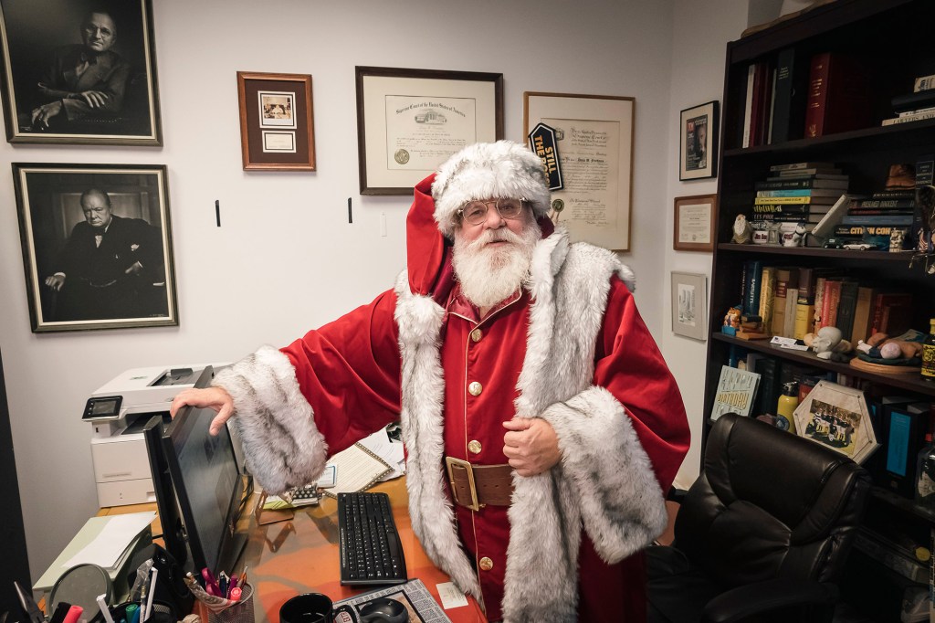 lawyer Dana "Santa" Friedman, dressed as Santa Claus at his office in the Astor building, lower Manhattan. 217 Broadway, New York, NY
