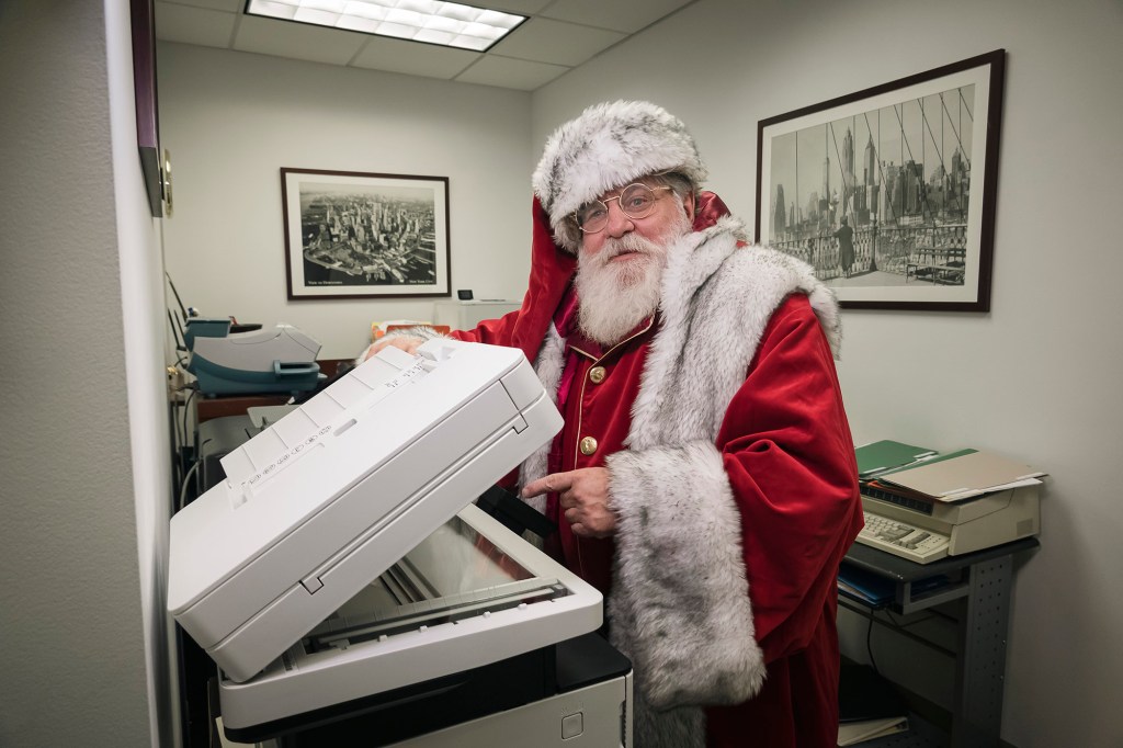 lawyer Dana "Santa" Friedman, dressed as Santa Claus at his office in the Astor building, lower Manhattan. 217 Broadway, New York, NY
