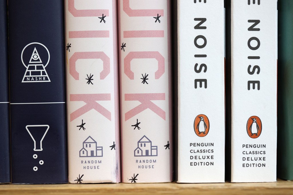 a stack of books on a shelf published by simon and schuster and random house