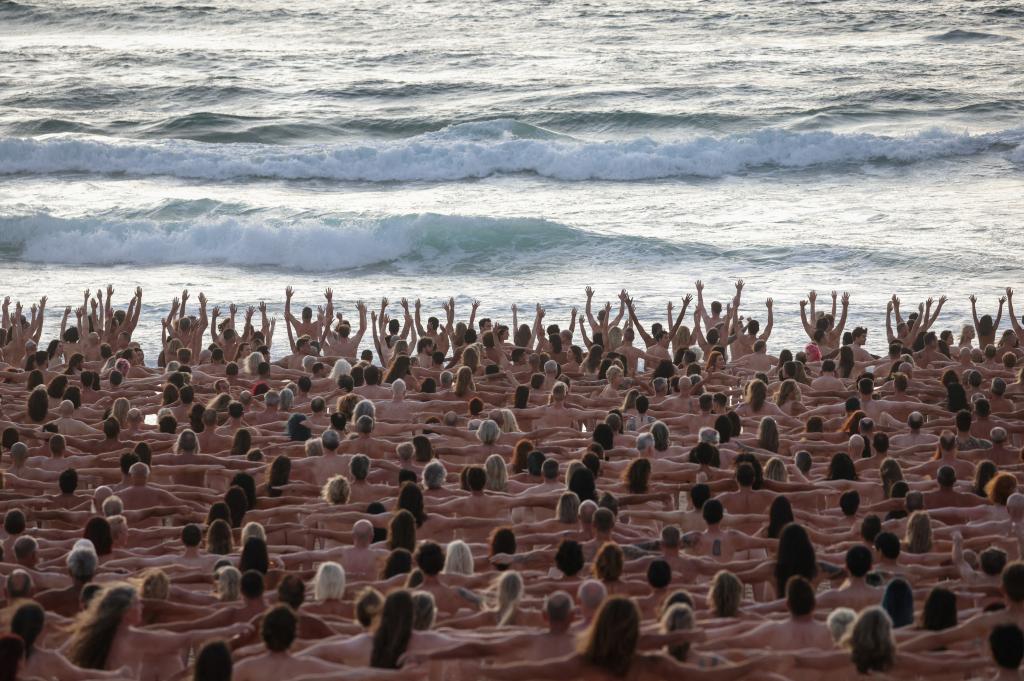 People posed naked at Australia's Photographer Spencer Tunick, who is known for his nude group shots in public places, took the snaps Saturday morning on Sydney's Bondi Beach for a photo to raise awareness for skin cancer.