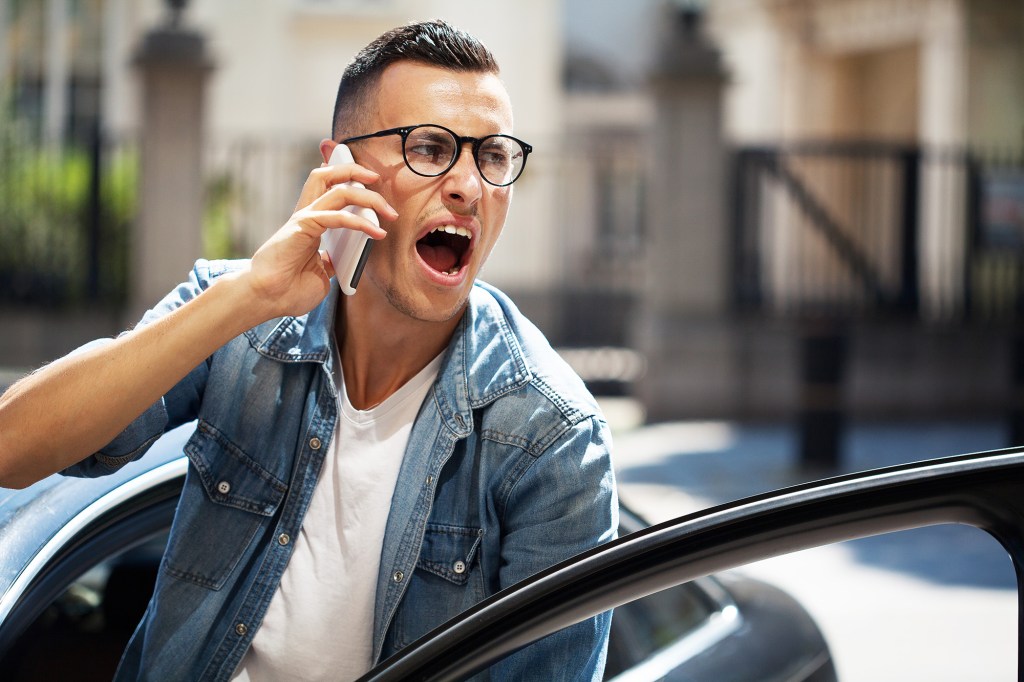 Angry young man talking on the phone