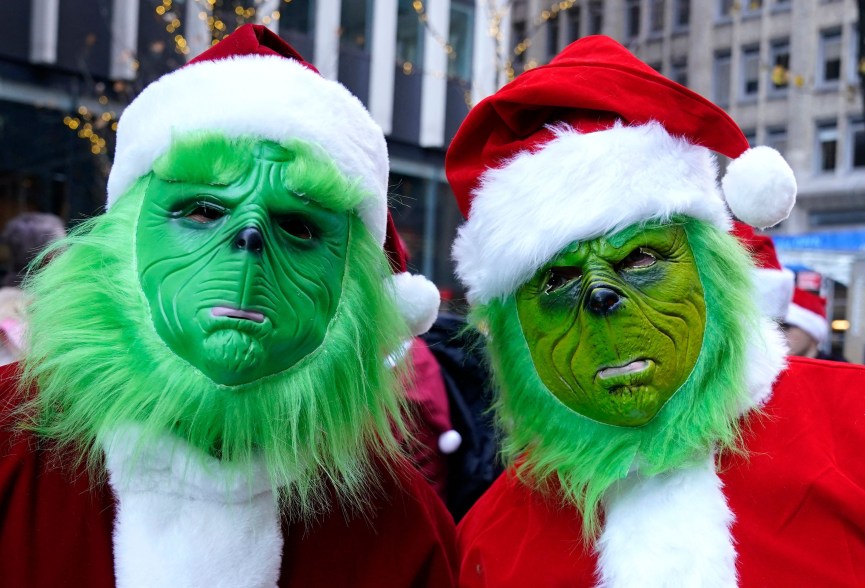 Two people dressed as the Grinch during Santa Con 2022, on Saturday, Dec. 10, 2022.