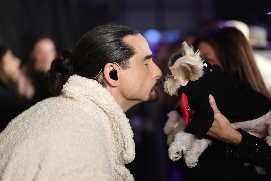 Kevin Richardson of Backstreet Boys kisses a dog at iHeart Radio Jingle Ball on Friday, Dec. 10, 2022.