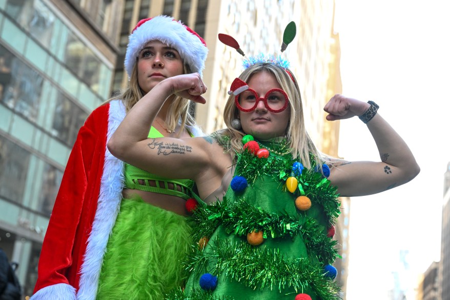 Two partiers dressed in festive costumes during Santa Con 2022, on Saturday, Dec. 10 in Manhattan, NY.