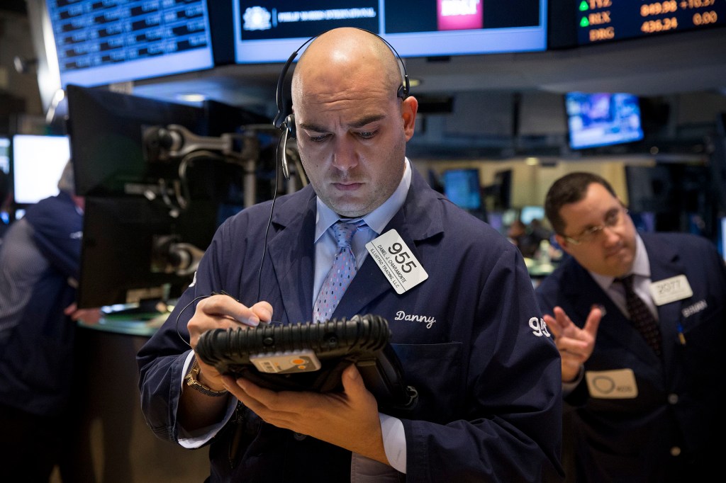 Traders work on the floor of the New York Stock Exchange.