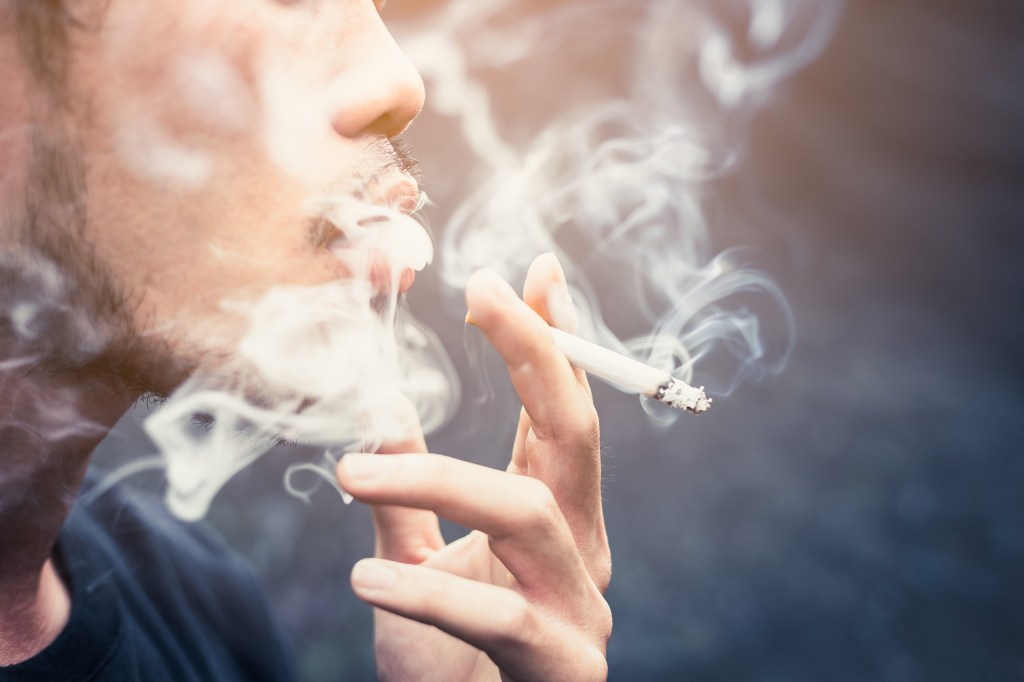 a person smoking a drug-laced cigarette