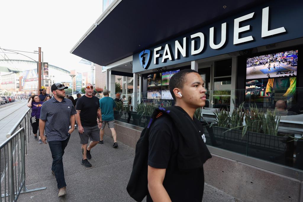 Fans walk past a Fanduel sports betting location at Footprint Center before Game Five of the Western Conference First Round NBA Playoffs between the Phoenix Suns and the New Orleans Pelicans on April 26, 2022.