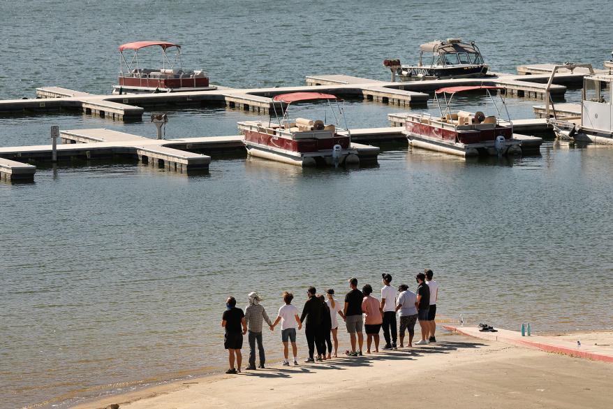 Cast members from the TV Show "Glee" and friends held hands as they shouted "Say her name - Naya" as they gathered on the Lake Piru boat launch