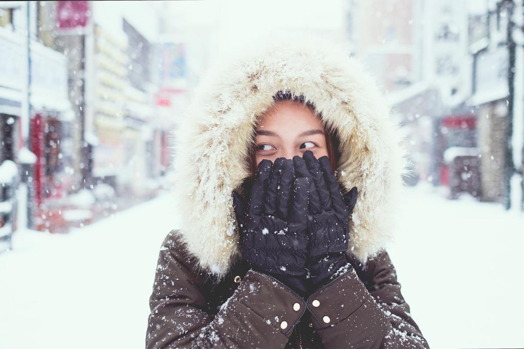 Portrait Of Young Woman In Snow During Winter