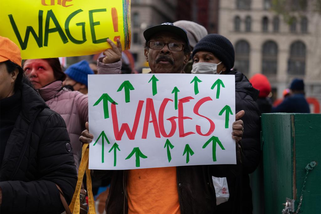 A picture of people protesting about NY wages.