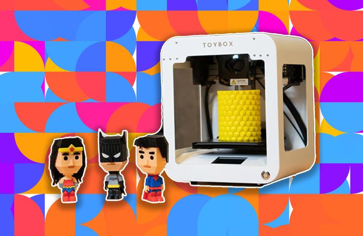 Toybox 3D printer on a colorful background.