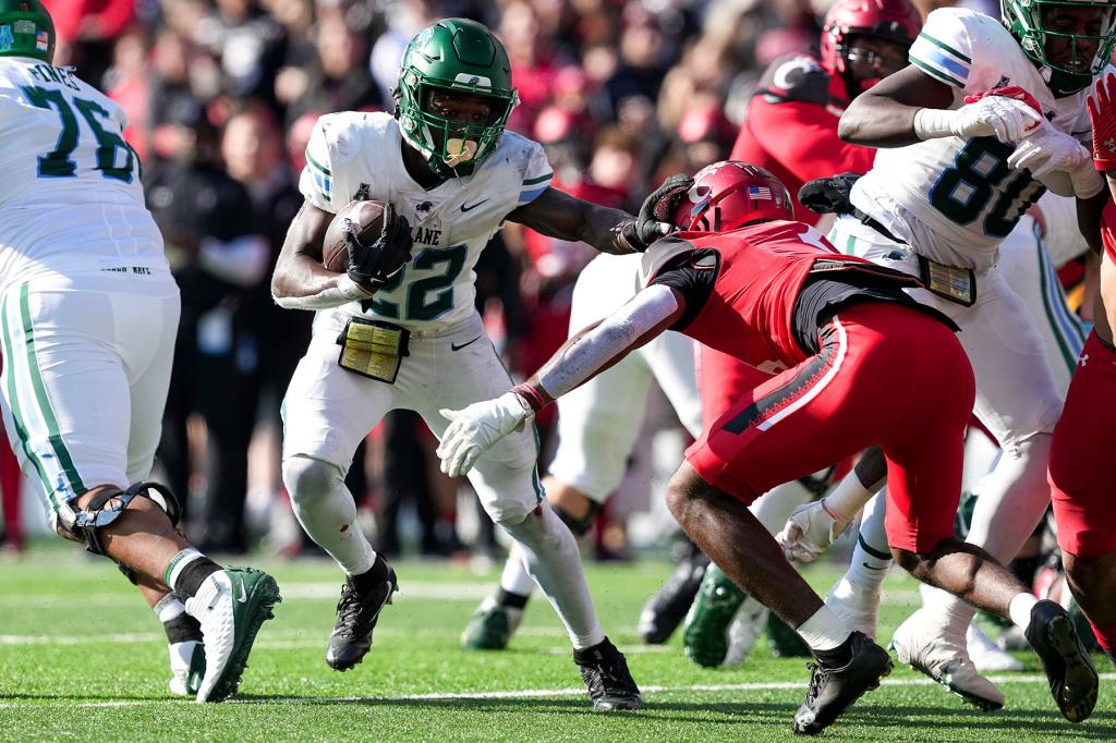 Tyjae Spears #22 of the Tulane Green Wave runs with the ball while being chased by Ja'Von Hicks #3 of the Cincinnati Bearcats in the second quarter at Nippert Stadium on November 25, 2022 in Cincinnati, Ohio.