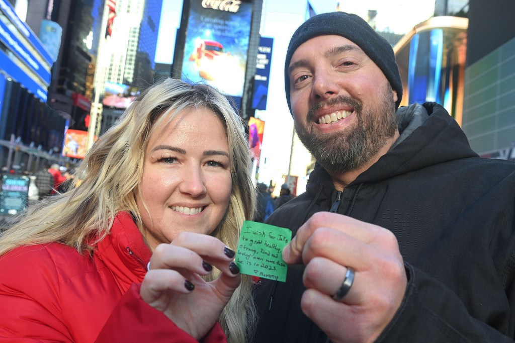 man and woman hold up their wish