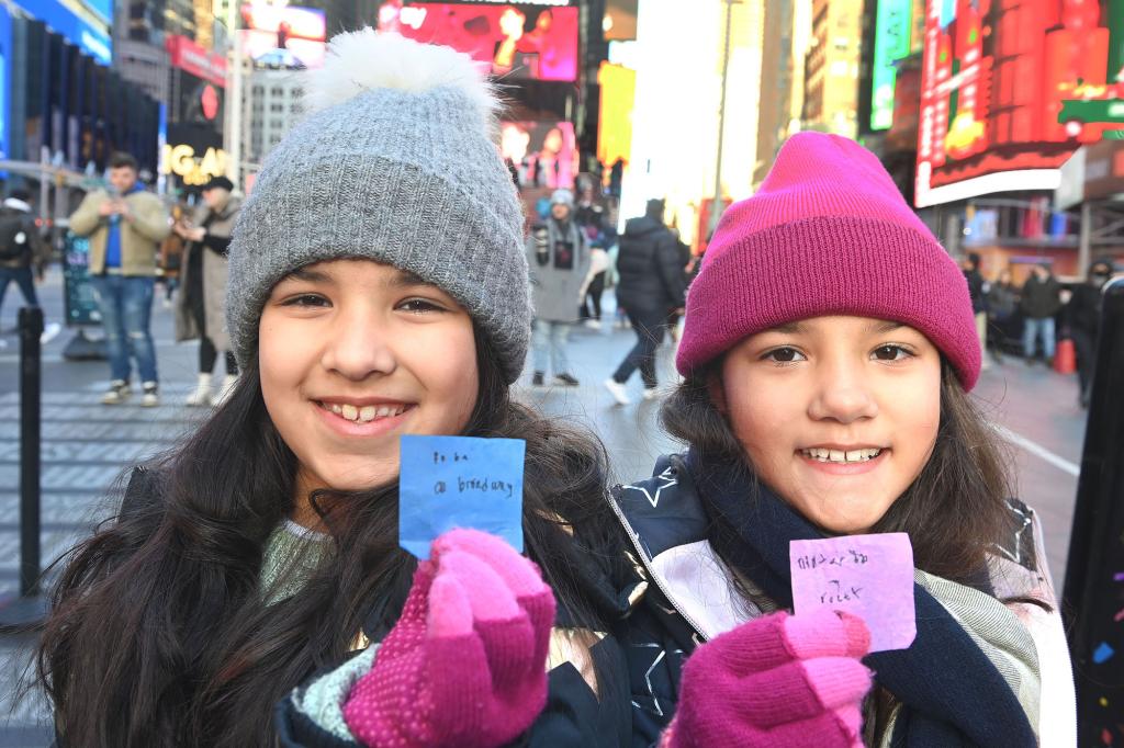 Girls in hats and gloves hold up their wishes