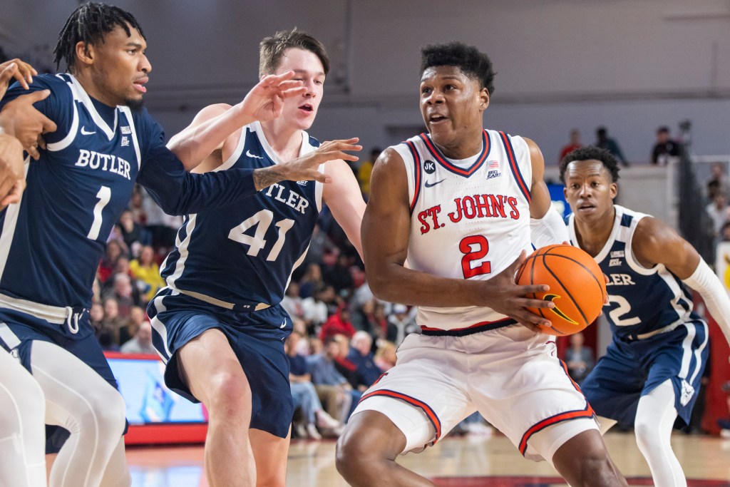 AJ Storr, who started for his second straight game, drives past Simas Lukosius during St. John's win.