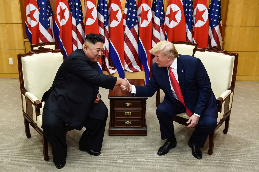 Then-President Donald Trump and Kim Jong Un greet each other during their summit on June 30, 2019, in South Korea.