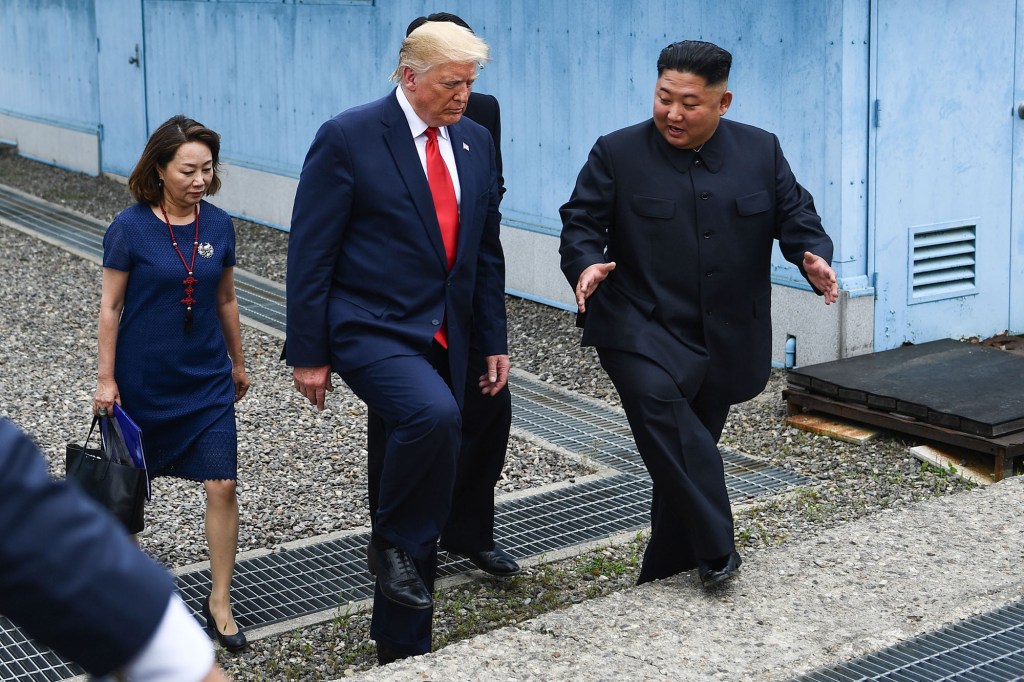 Then-President Donald Trump and North Korea's Kim Jong Un step over the military demarcation line separating the Koreas on June 30, 2019. 