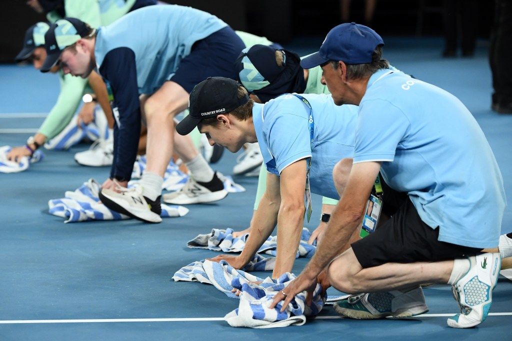 Ballkids wipe rain off the court at the 2020 Australian Open on Jan. 31, 2020.