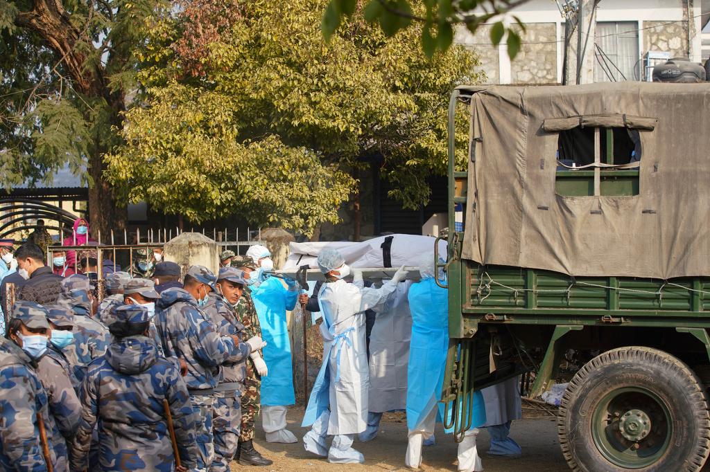 Medical personnel load the body of a victim onto a truck to be transported to Kathmandu, in Pokhara, Nepal, Tuesday, Jan 17, 2023.