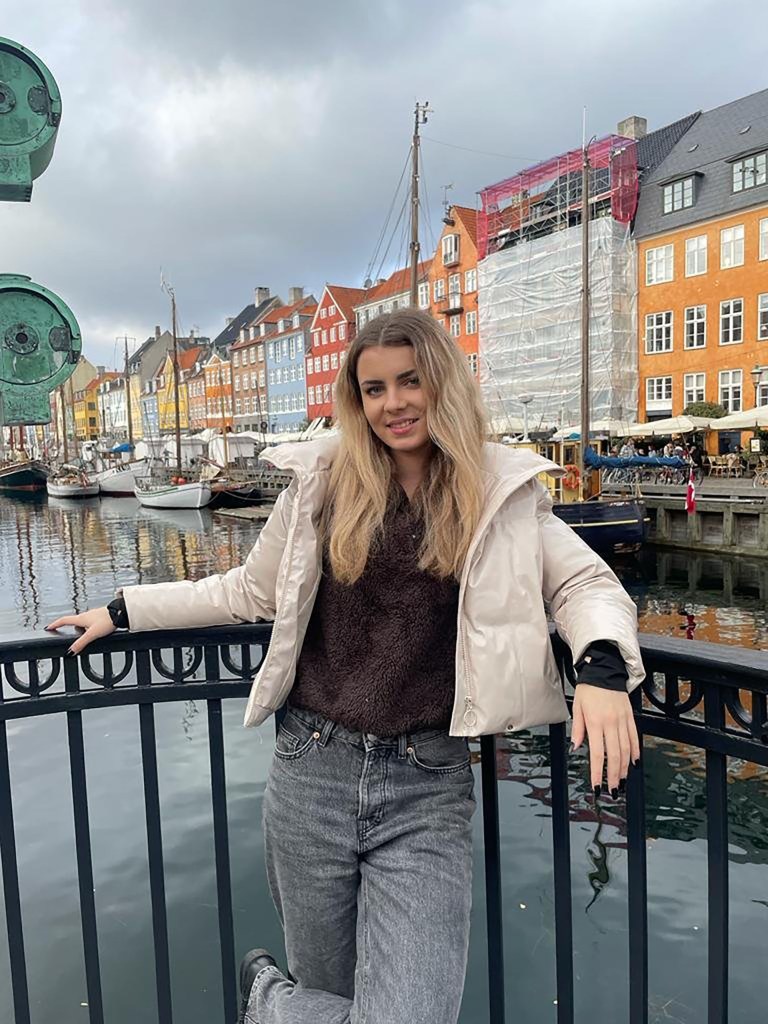 Daria Gusa is pictured standing by a river.